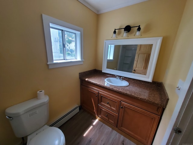 bathroom featuring wood-type flooring, vanity, toilet, and a baseboard heating unit