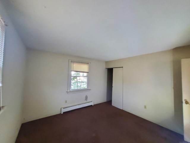 67 Enfield St Unit 37, Hartford, CT 06112 - unfurnished bedroom featuring a baseboard heating unit, dark carpet, and a closet