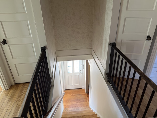 stairs featuring wood finished floors