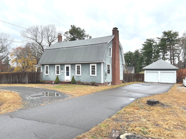 view of front of home with a garage and an outdoor structure