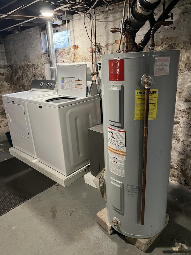 interior space with electric water heater and washer and clothes dryer