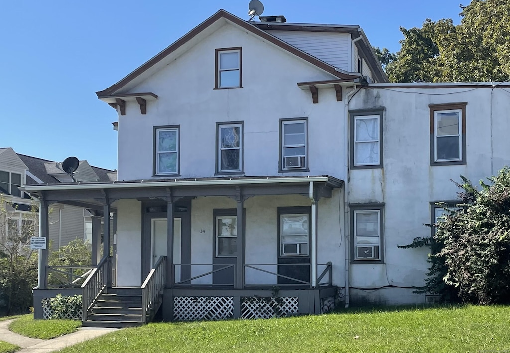 14 Fairfield Ave, Norwalk, CT 06854 - view of front facade with a porch, stucco siding, and a front yard