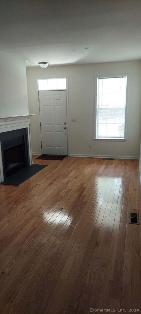 unfurnished living room featuring wood-type flooring