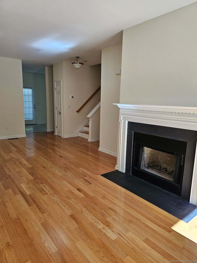 unfurnished living room featuring light hardwood / wood-style floors