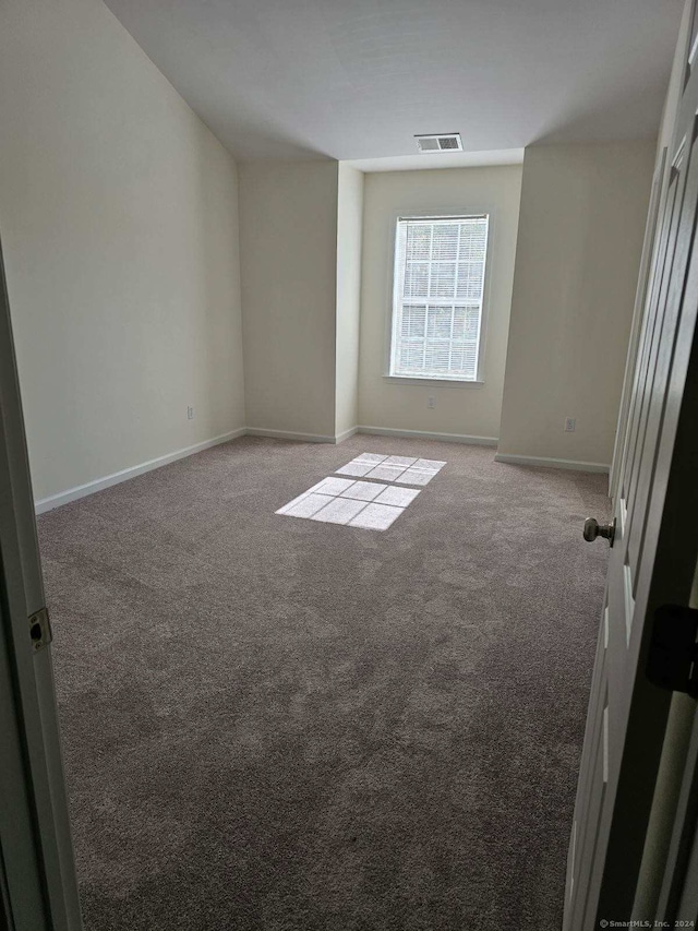 empty room featuring light carpet