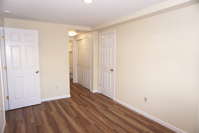 unfurnished bedroom featuring dark hardwood / wood-style flooring