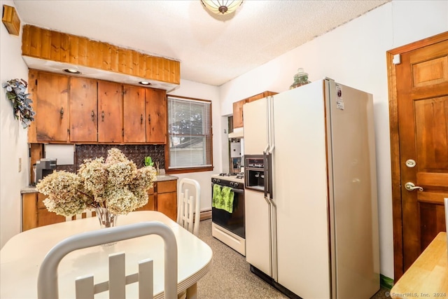 kitchen featuring tasteful backsplash, white appliances, and a textured ceiling