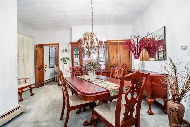 carpeted dining area with an inviting chandelier, baseboard heating, and crown molding