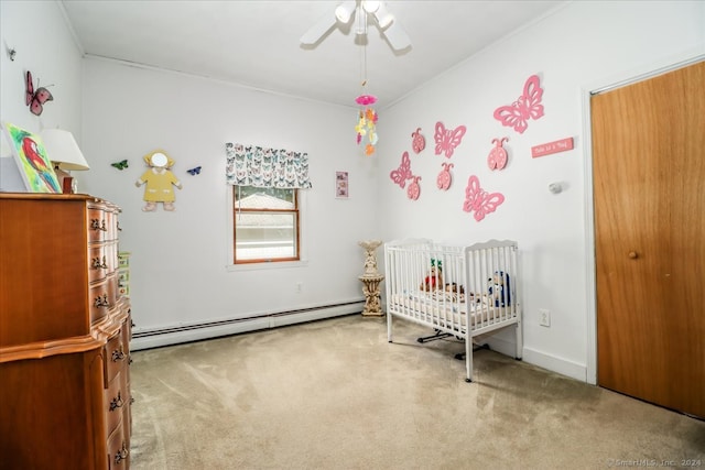 bedroom with a nursery area, ceiling fan, carpet flooring, and a baseboard radiator