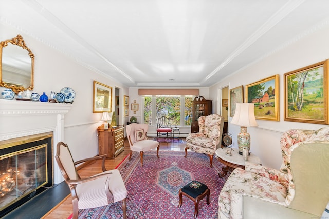 living room with ornamental molding, a baseboard radiator, and hardwood / wood-style floors