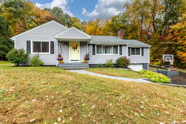 single story home with a front yard and a garage