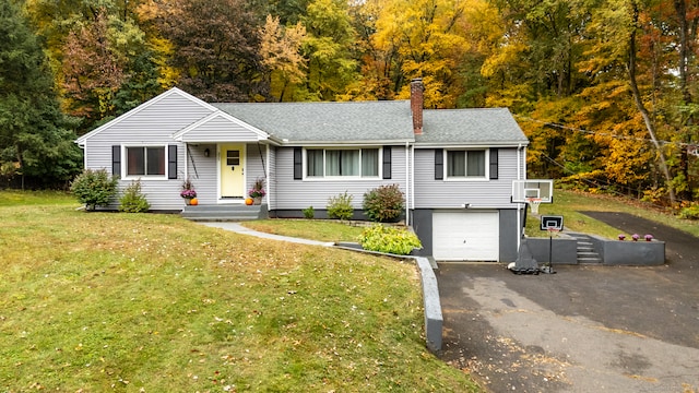 view of front of property with a front yard and a garage