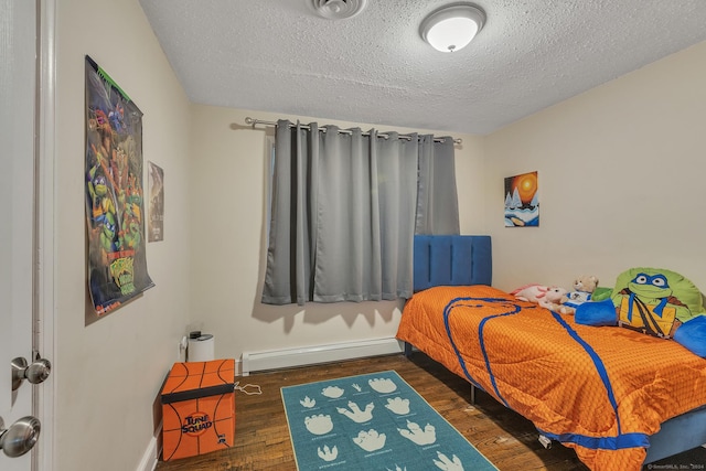 bedroom featuring a textured ceiling, wood finished floors, baseboards, and a baseboard radiator