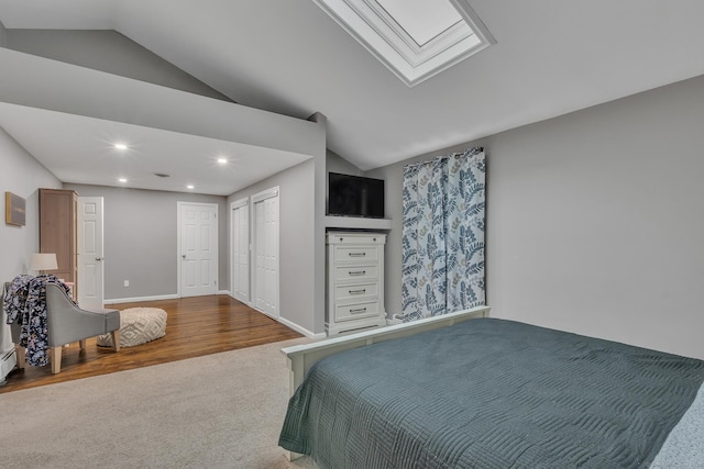 bedroom featuring carpet, lofted ceiling with skylight, recessed lighting, and baseboards