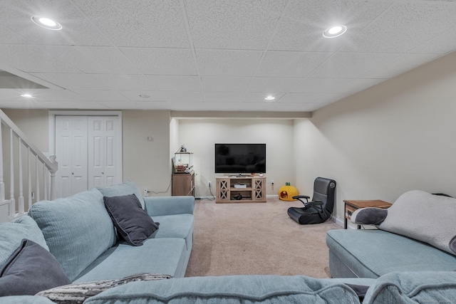 carpeted living area featuring stairs, recessed lighting, and baseboards