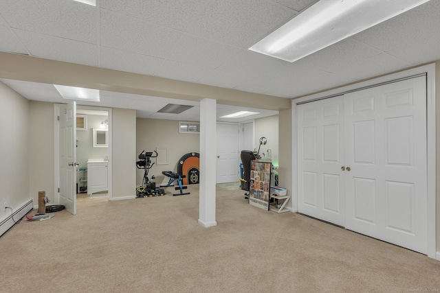 workout room with carpet and a drop ceiling