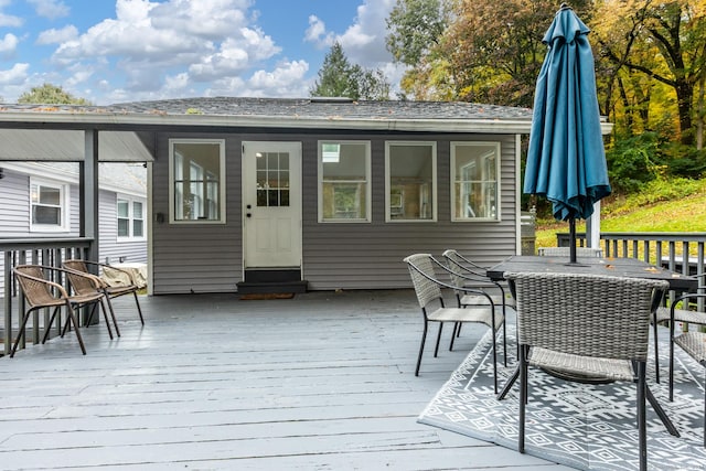 deck featuring outdoor dining area and entry steps