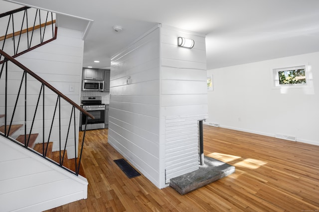 staircase with hardwood / wood-style floors