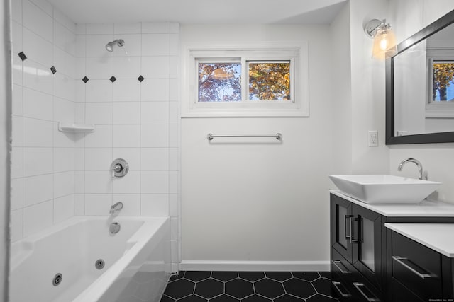 bathroom with vanity, tiled shower / bath, and tile patterned flooring