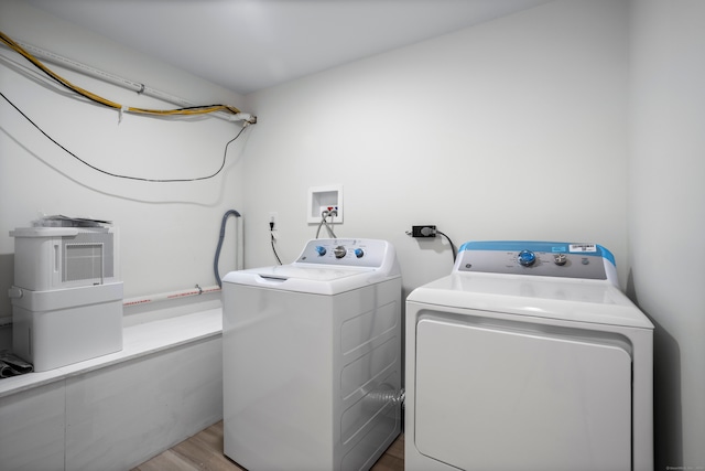 washroom featuring separate washer and dryer and light wood-type flooring