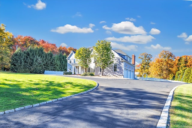 view of front of home featuring a front lawn and a garage