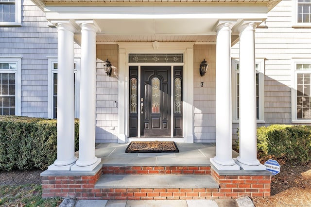 view of exterior entry with a porch