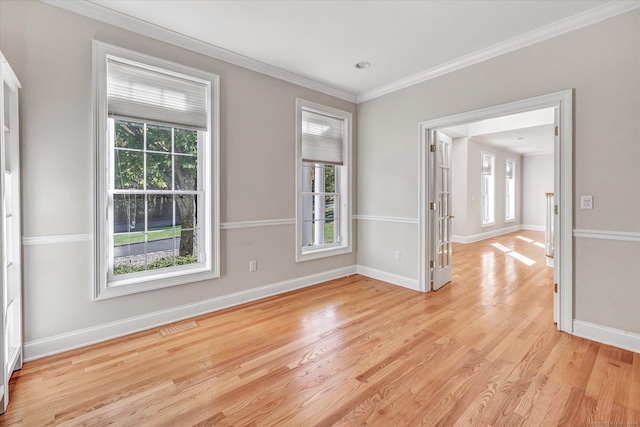 spare room featuring light hardwood / wood-style floors and crown molding