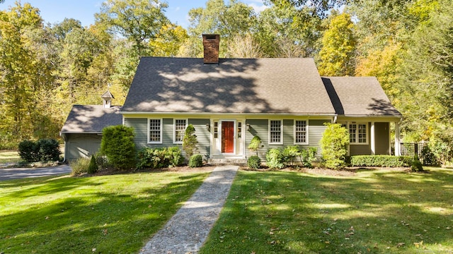 cape cod-style house featuring a front lawn and a garage