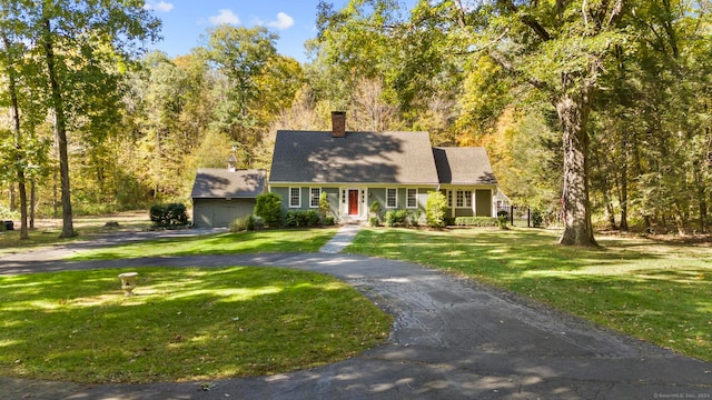 cape cod home with a front lawn