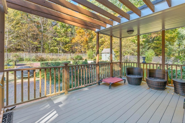 wooden deck with a pergola and a storage unit