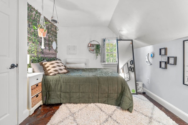 bedroom with lofted ceiling and dark hardwood / wood-style flooring