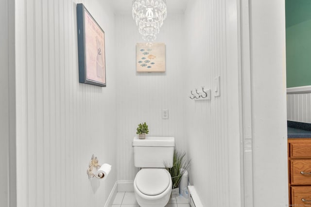 bathroom with tile patterned floors, a chandelier, toilet, and a baseboard radiator