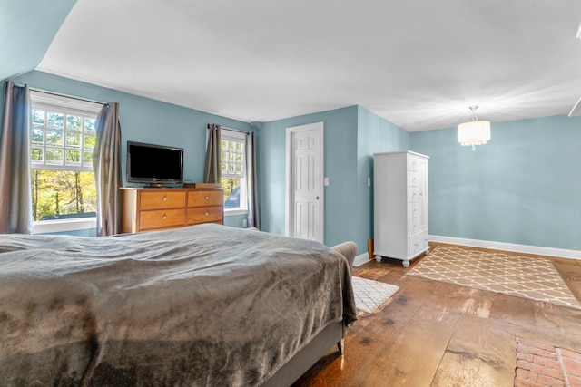 bedroom featuring wood-type flooring and multiple windows