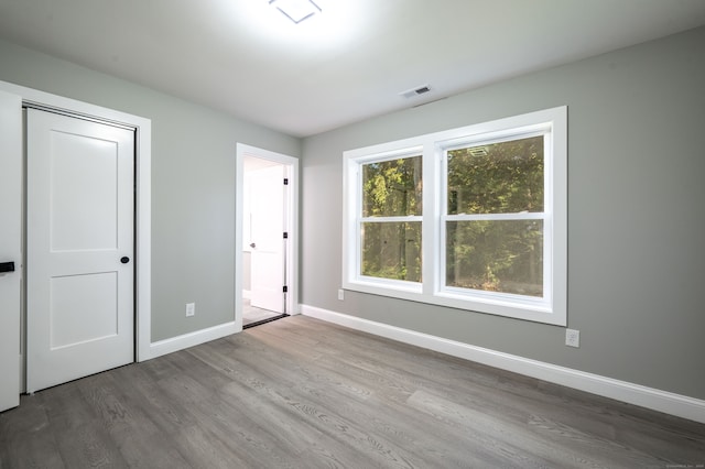 unfurnished bedroom with a closet and wood-type flooring