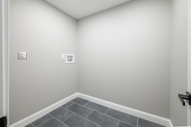 washroom featuring dark tile patterned flooring and hookup for a washing machine