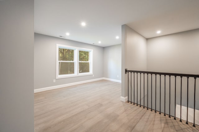 spare room featuring light wood-type flooring