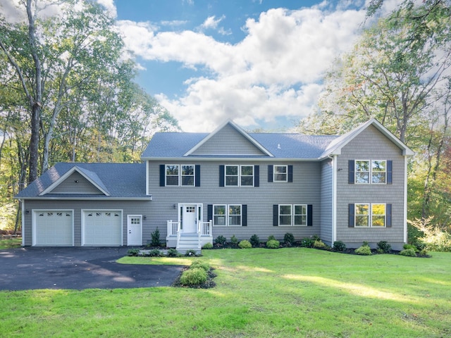 view of front facade with a front yard and a garage