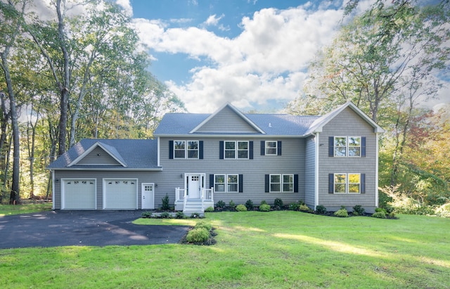 view of front facade featuring a front lawn and a garage