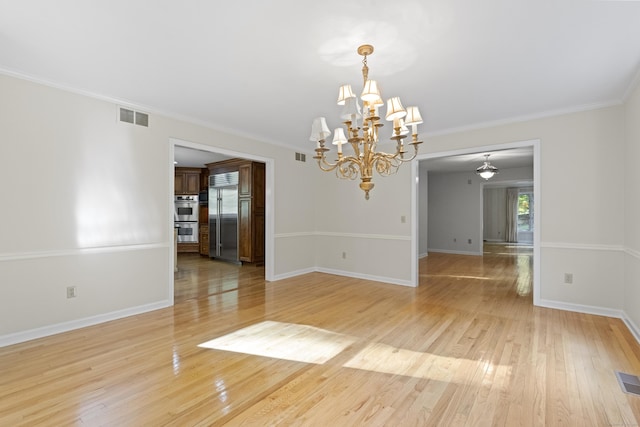 unfurnished room with crown molding, light hardwood / wood-style flooring, and an inviting chandelier