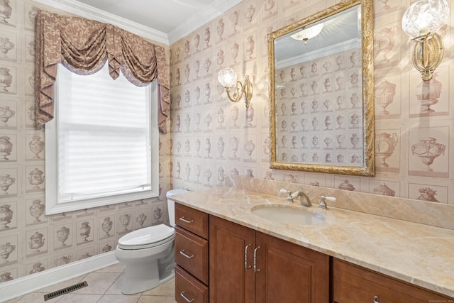 bathroom with tile patterned floors, vanity, toilet, and crown molding