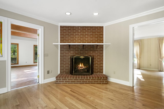 unfurnished living room with a brick fireplace, light hardwood / wood-style flooring, and ornamental molding