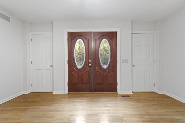 foyer entrance with light hardwood / wood-style floors