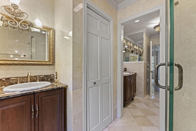 bathroom featuring vanity, crown molding, a shower with shower door, and tile walls