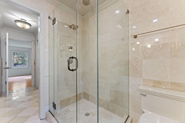 bathroom with toilet, a shower with door, crown molding, and tile walls