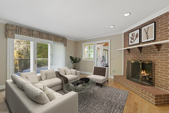 living room with light hardwood / wood-style flooring, crown molding, and a brick fireplace