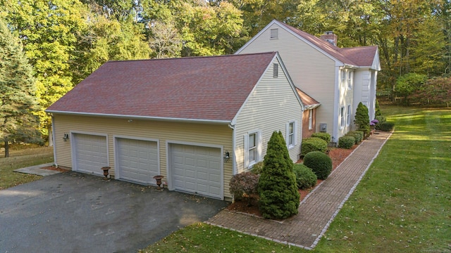 view of property exterior featuring a yard and a garage