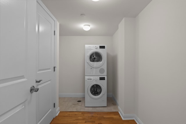 washroom featuring stacked washer / drying machine and light wood-type flooring