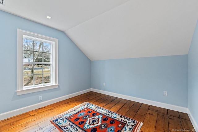 additional living space featuring hardwood / wood-style flooring, recessed lighting, baseboards, and lofted ceiling