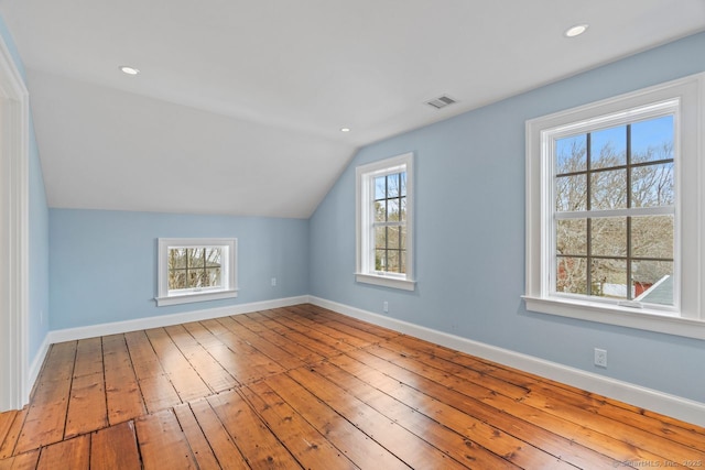 bonus room with visible vents, baseboards, and hardwood / wood-style flooring