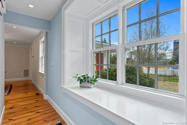 hall with recessed lighting, visible vents, light wood-style flooring, and baseboards